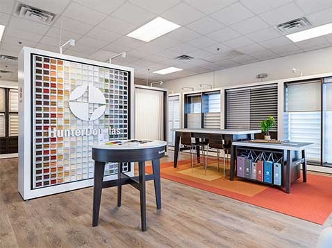 Store interior showcasing several different types of window coverings